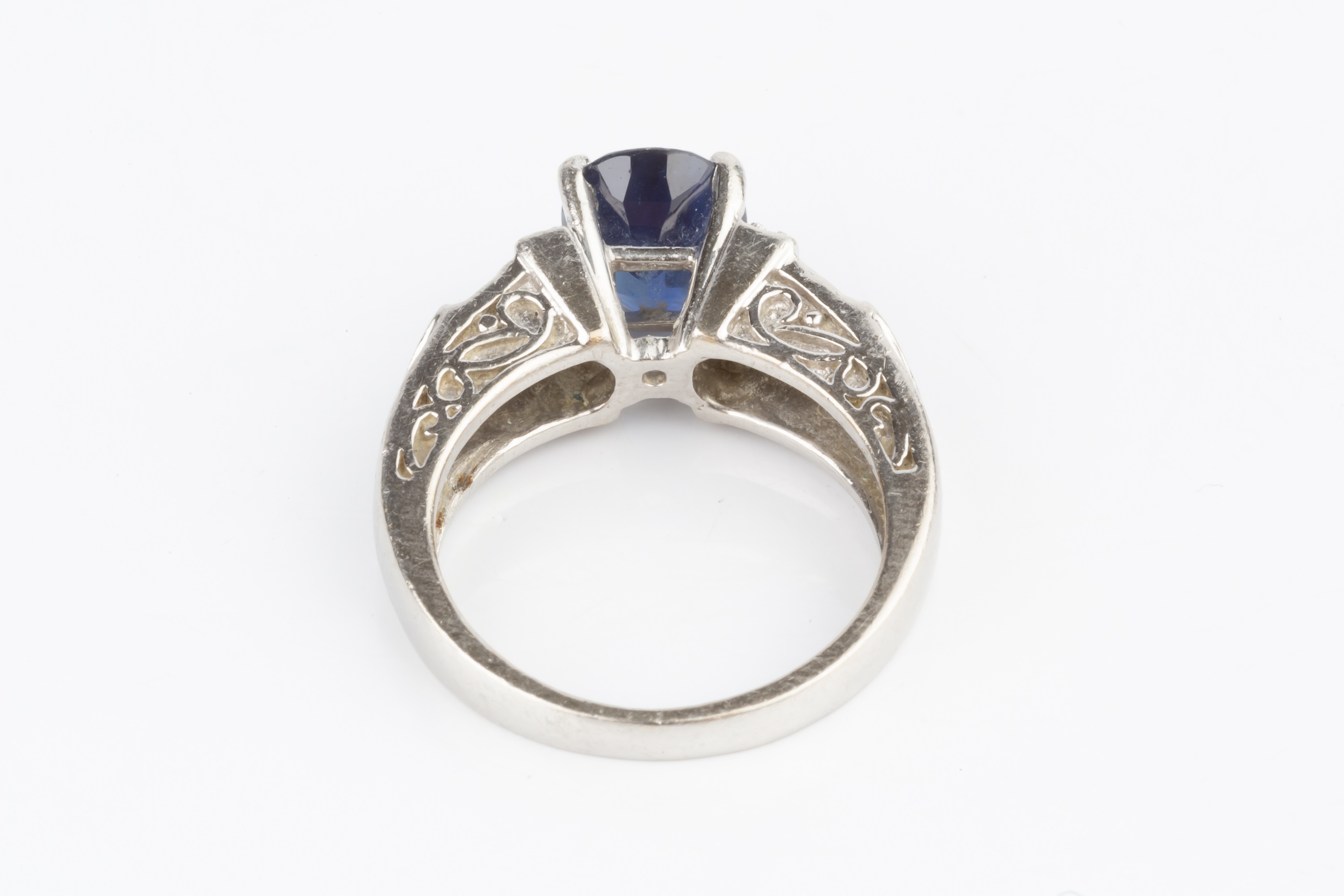 A sapphire and diamond dress ring, the oval mixed-cut sapphire claw set between graduating shoulders - Image 4 of 4