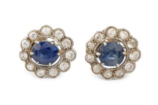 A pair of sapphire and diamond cluster ear clips, the oval cut sapphires each claw set within a