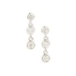 A pair of 18ct white gold and diamond earrings, each with three collet-set brilliant cut stones