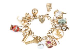 A 9ct gold curb link charm bracelet, with padlock clasp, hung with assorted gold and gold mounted