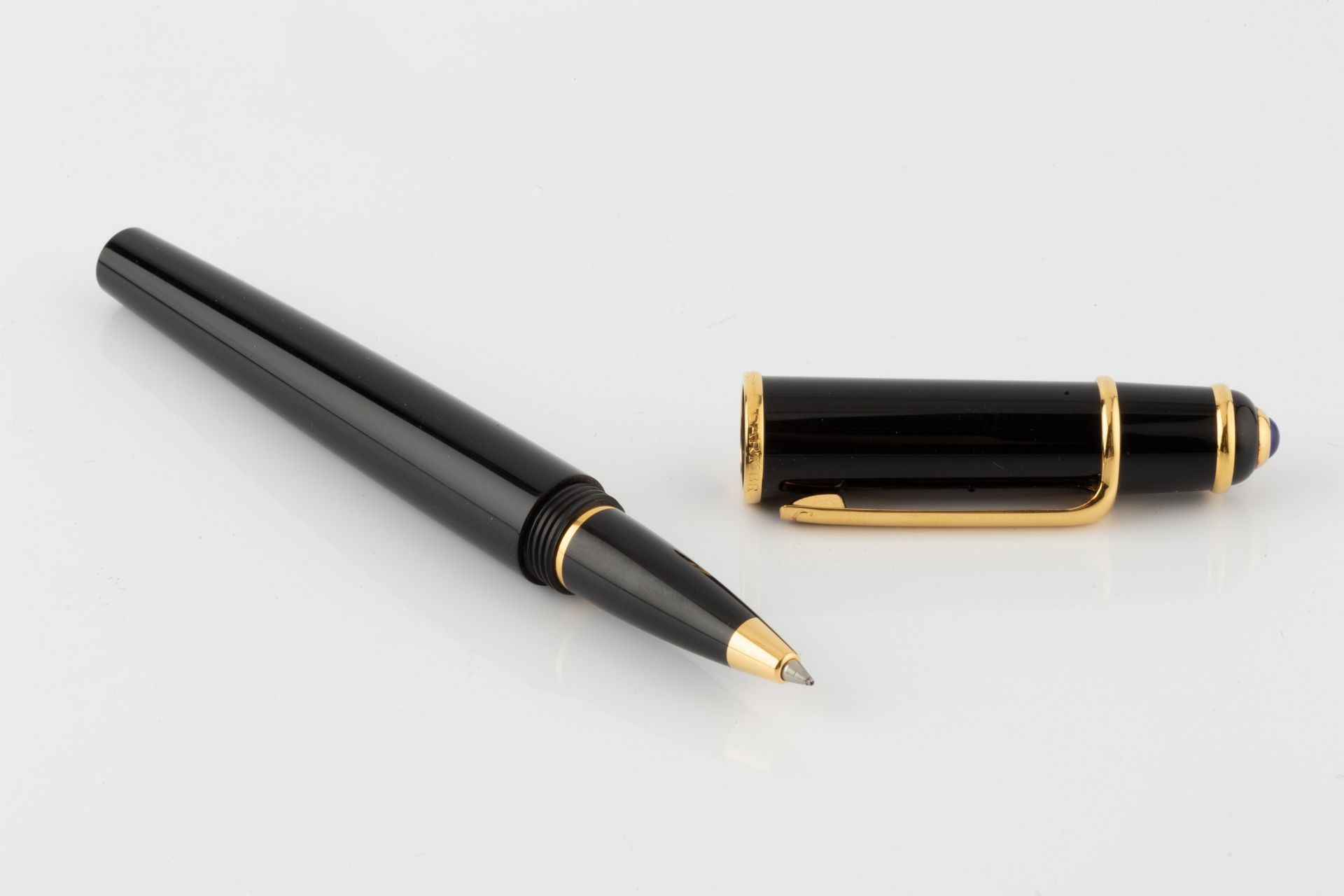 A Cartier ball point pen, in black with blue resin cabochon mounted lid, no. 106104, 14cm long - Image 2 of 2
