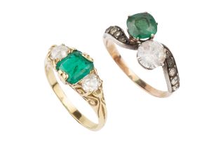 An emerald and diamond three stone ring, the square cushion cut stone flanked by old cut diamonds,
