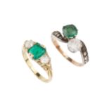 An emerald and diamond three stone ring, the square cushion cut stone flanked by old cut diamonds,