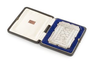 A late Victorian silver card case, of shaped rectangular outline, engraved with stylised scrolling