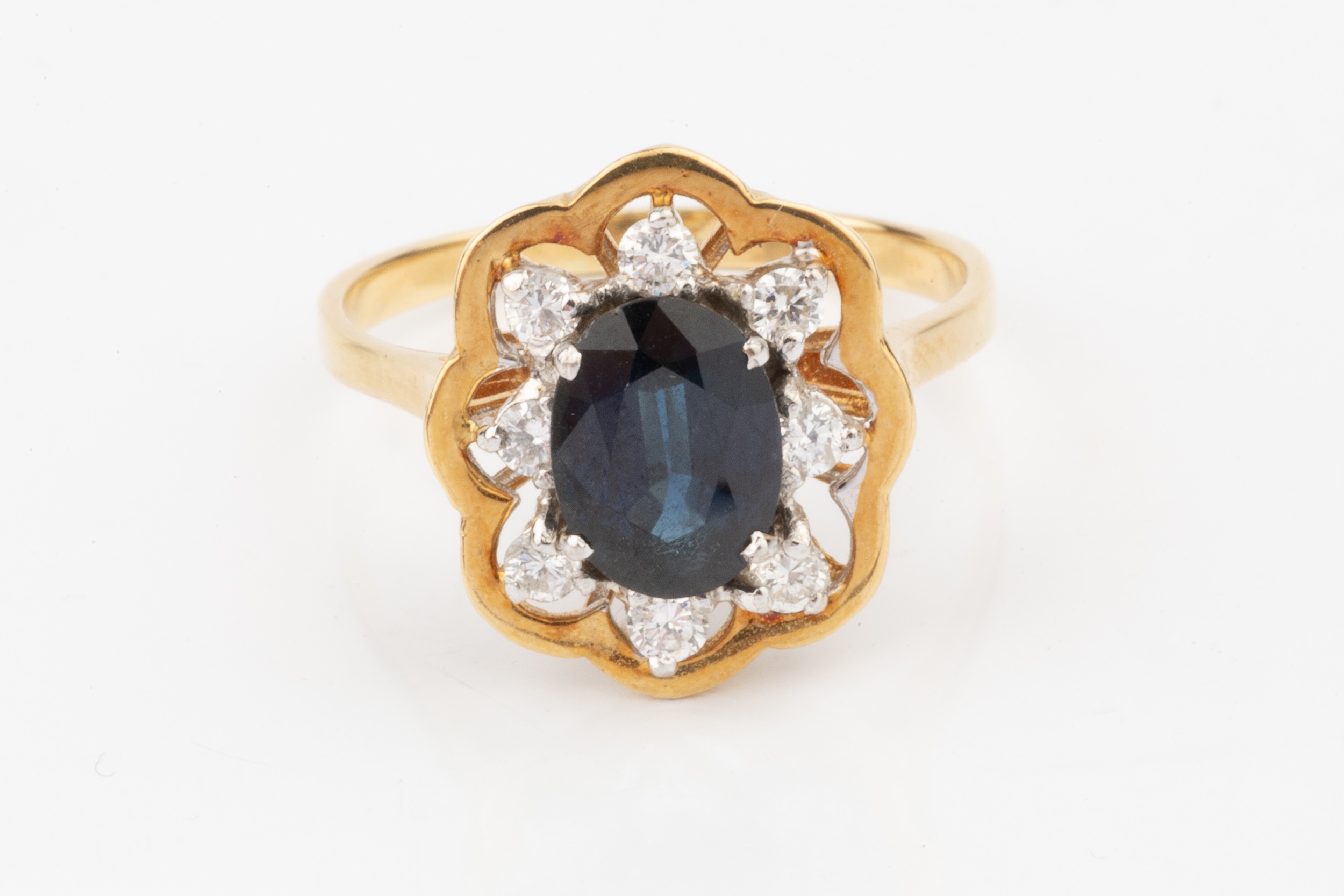 A sapphire and diamond dress ring, the oval central sapphire within a border of eight brilliant - Image 3 of 4