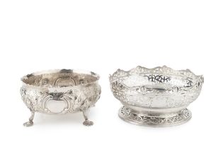 A late Victorian silver bowl, embossed and engraved with flowering foliage, on shaped legs with lily