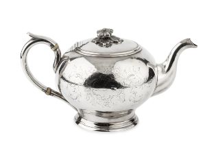 A mid 19th century American coin silver teapot, of globular form with flower cast finial, the handle