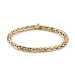 An 18ct gold bracelet, of hollow plaited design, the clasp set with a small cabochon blue stone,