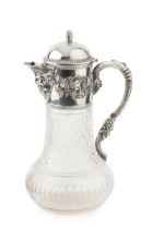 A Portuguese silver mounted cut glass claret jug, the hinged domed cover with barrel finial,
