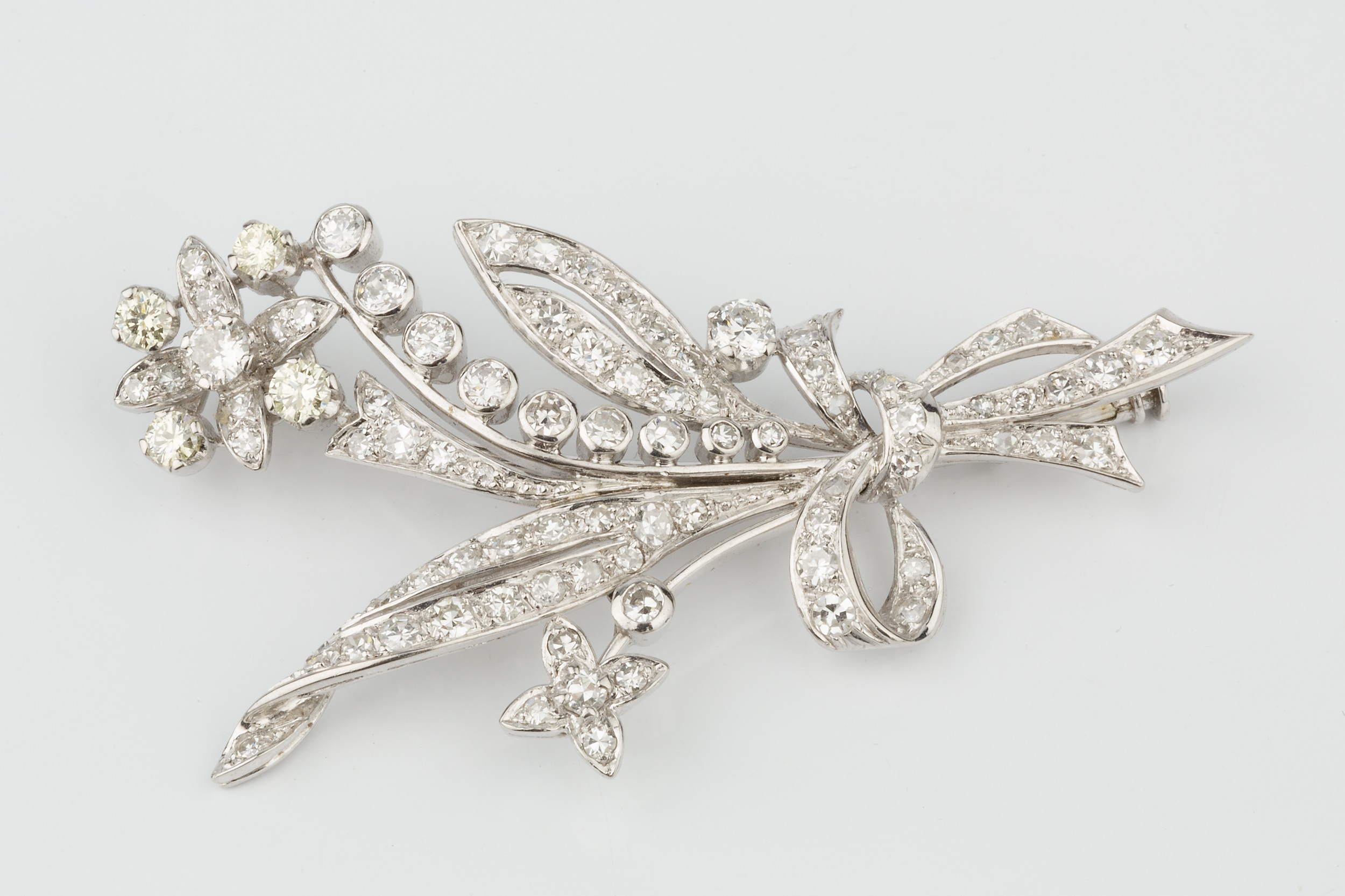 A diamond spray brooch, in the form of ribbon tied flowers and leaves, the main flower head set with - Image 3 of 3