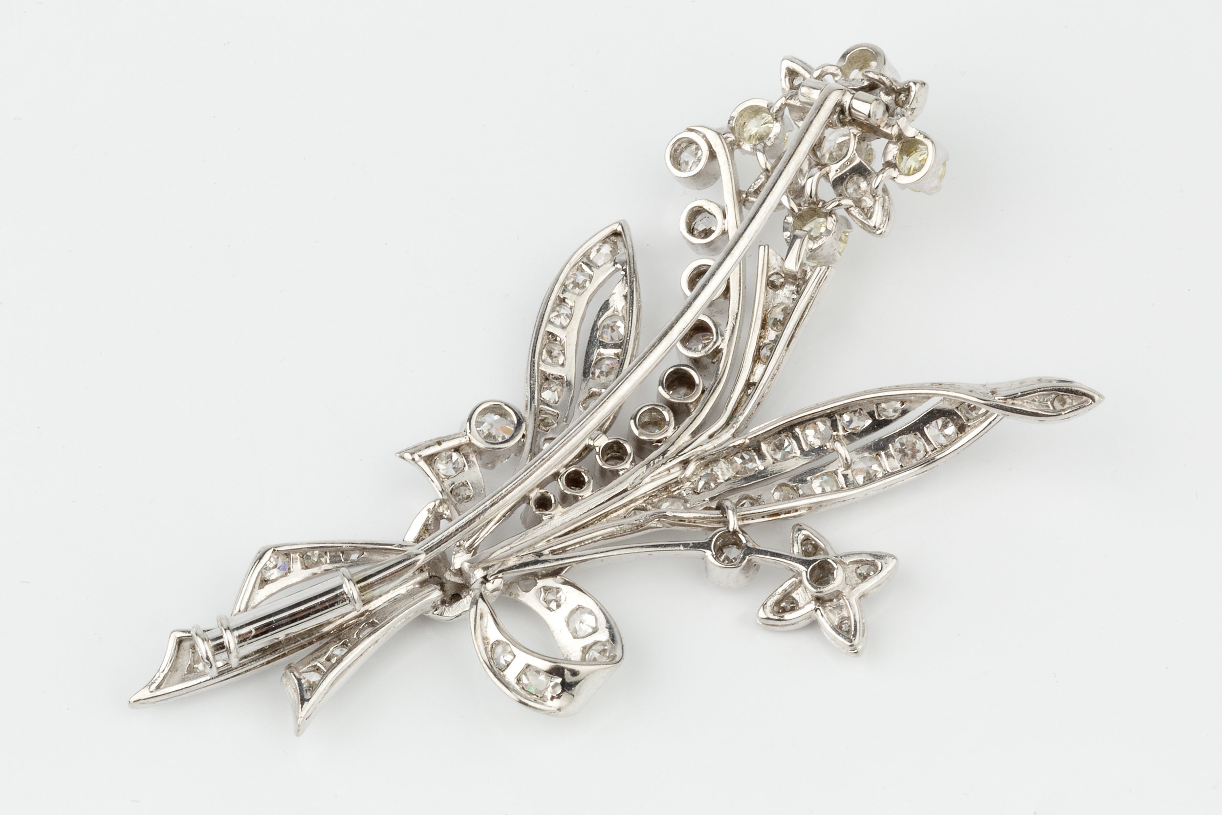 A diamond spray brooch, in the form of ribbon tied flowers and leaves, the main flower head set with - Image 2 of 3