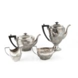 A late Victorian silver four piece tea and coffee service, of half lobed form, comprising teapot,