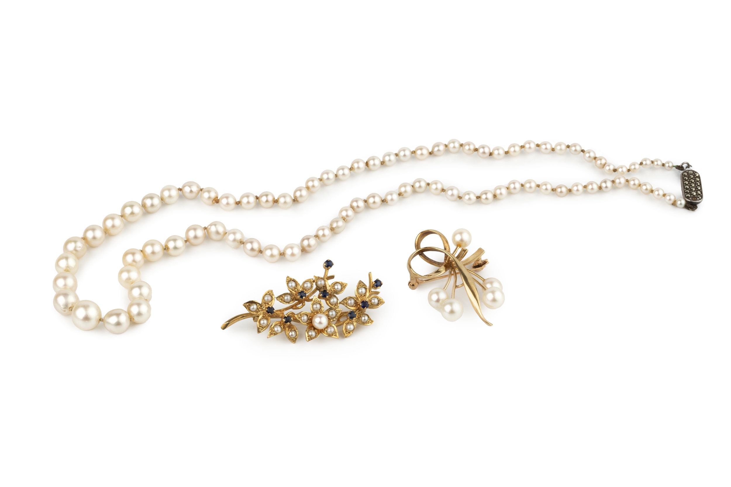 A 9ct yellow gold floral spray brooch, set throughout with split pearls and small sapphires,
