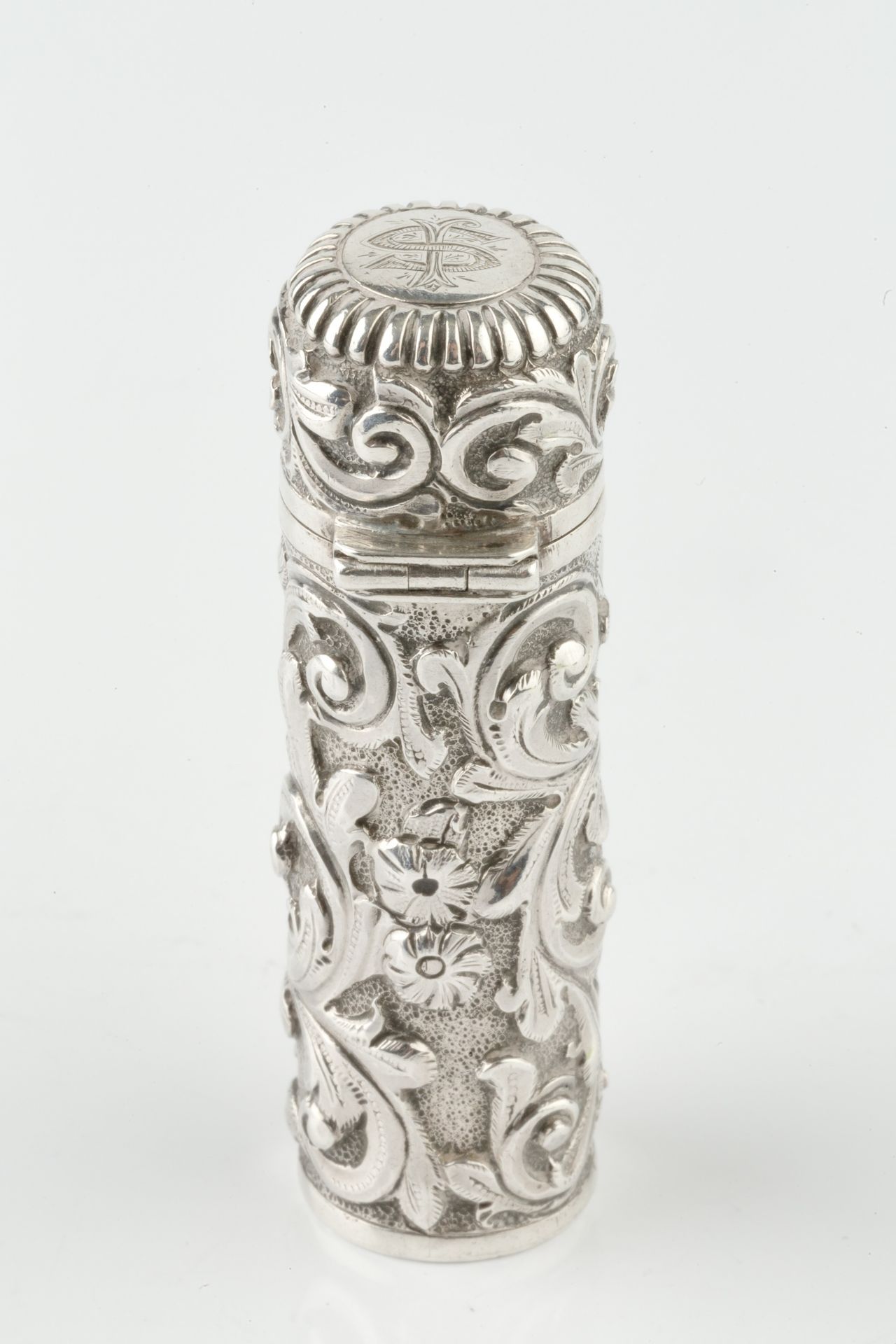 A late Victorian silver cylindrical scent bottle, embossed and engraved with stylised scrolling - Image 2 of 4