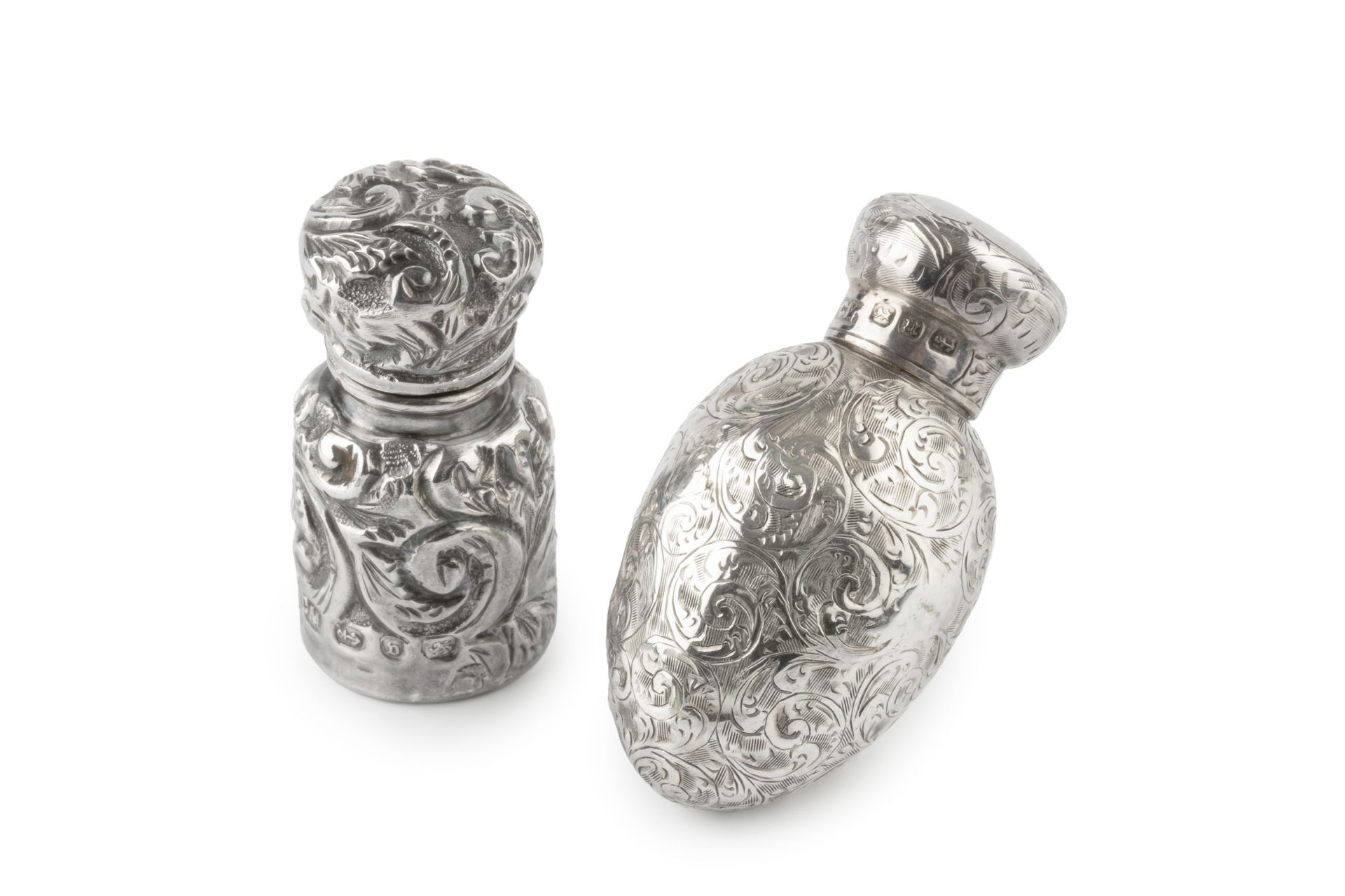 A late Victorian silver small scent bottle, with egg shaped body engraved with scrolling foliage,