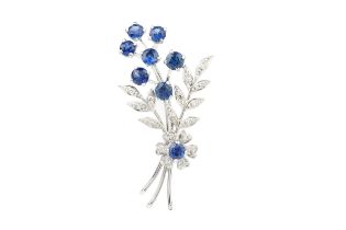 A sapphire and diamond floral spray brooch, set in 18ct white gold by Cropp & Farr, Birmingham 1961,