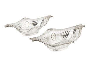 A pair of late Victorian silver sweetmeat baskets, of shaped oval form, having beaded borders with