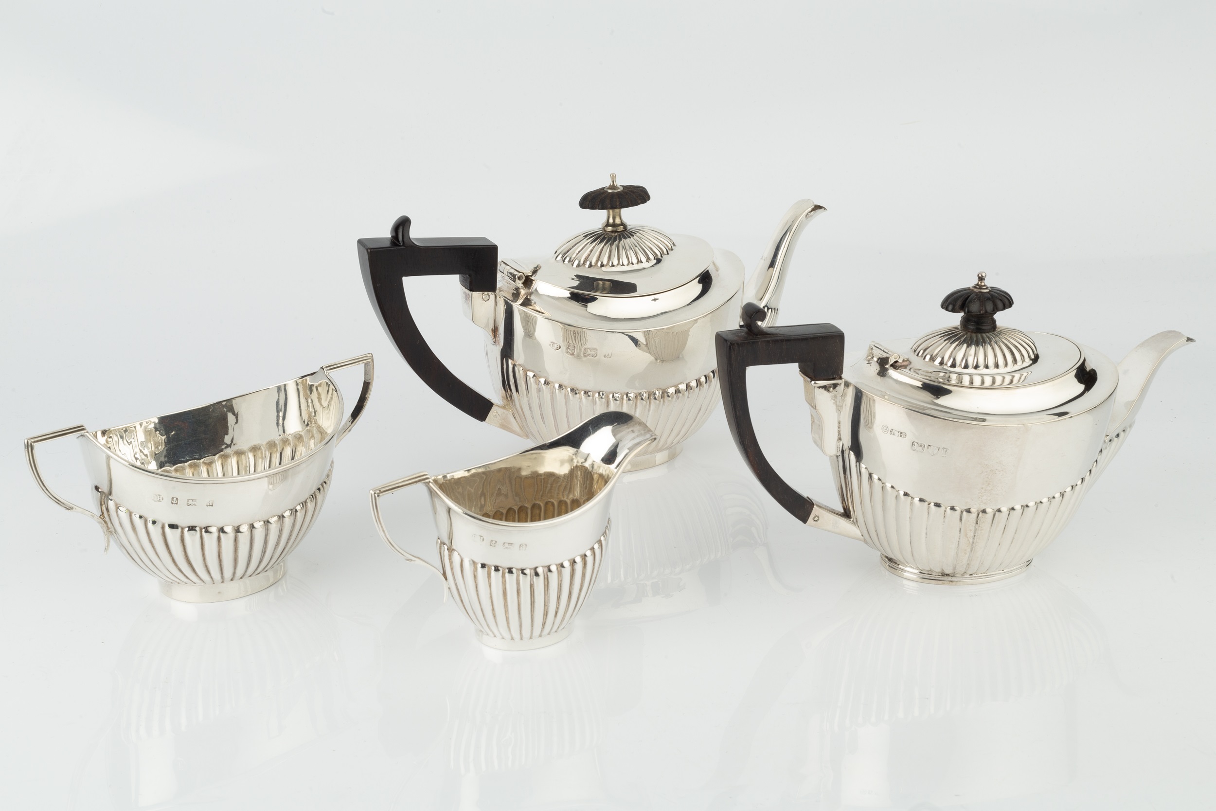 A late Victorian three piece bachelor's tea service, of half lobed form, the teapot with ebonised - Image 2 of 2
