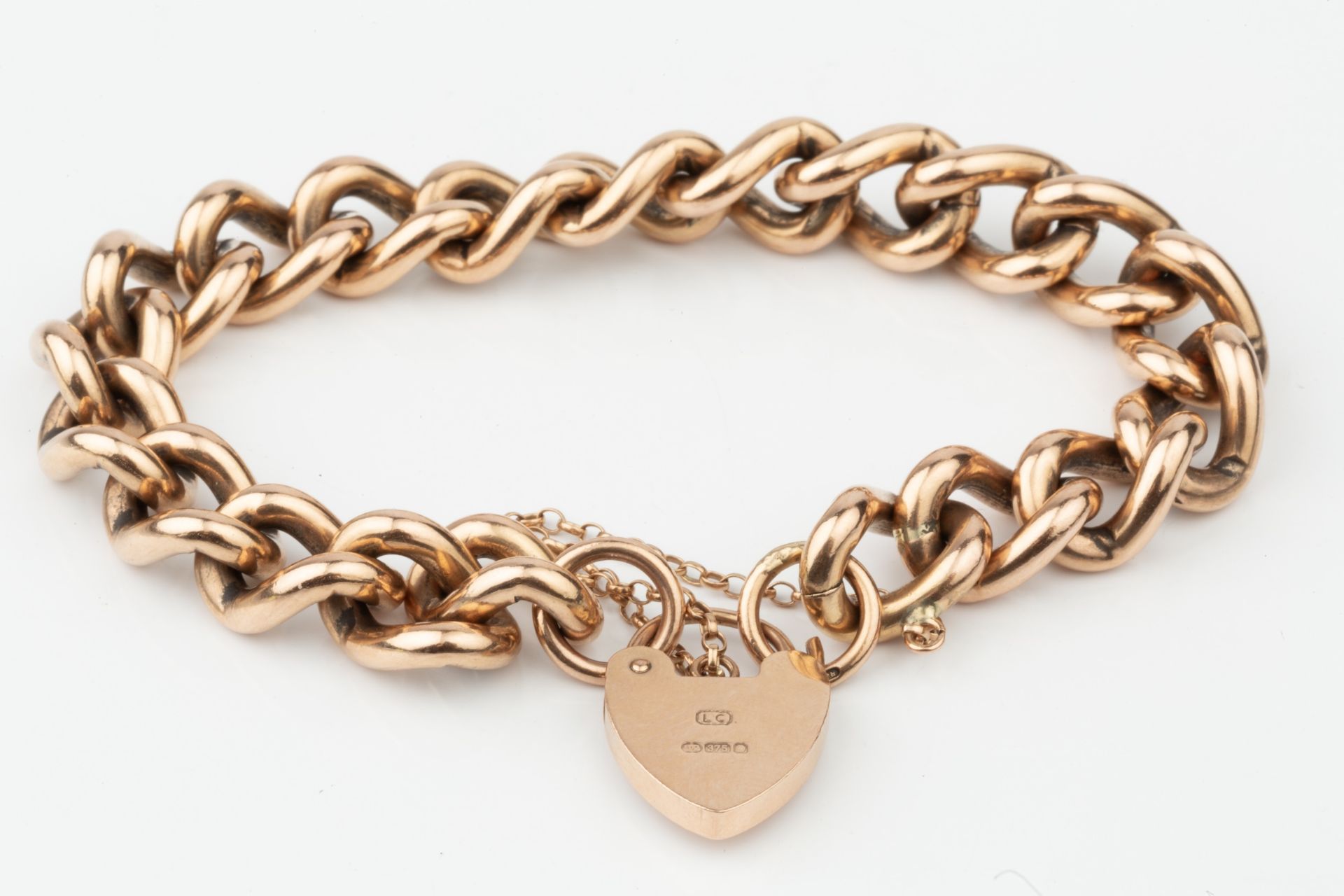A 9ct gold curb link bracelet, with padlock clasp and safety chain, 18.5cm long approx 56.7g - Bild 2 aus 2