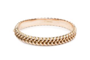 A Victorian 9ct rose gold hinged bangle, with an embossed bead and weave design, hallmarked for