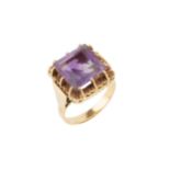 An amethyst cocktail ring, the square cut stone with raised claw setting to a yellow precious
