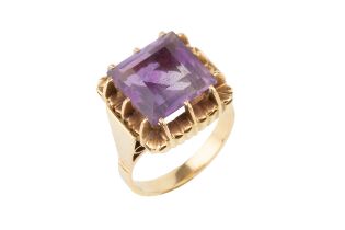 An amethyst cocktail ring, the square cut stone with raised claw setting to a yellow precious