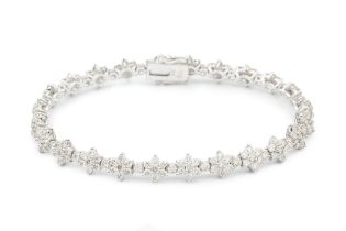 An 18ct white gold and diamond bracelet, set with a line of brilliant cut flowerhead clusters with