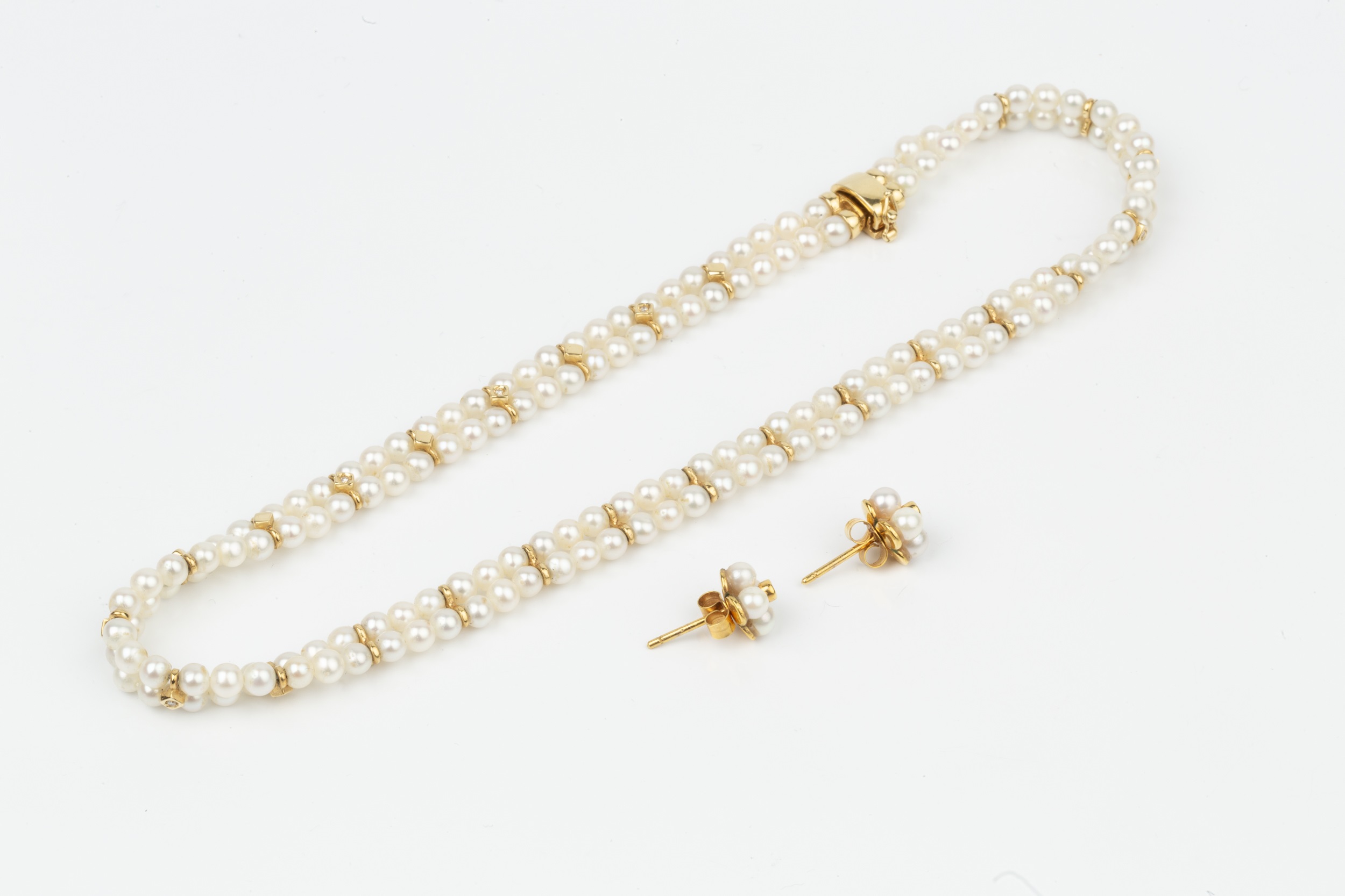 An 18ct gold and cultured pearl twin strand choker, the two strands united by alternating diamond - Image 2 of 2