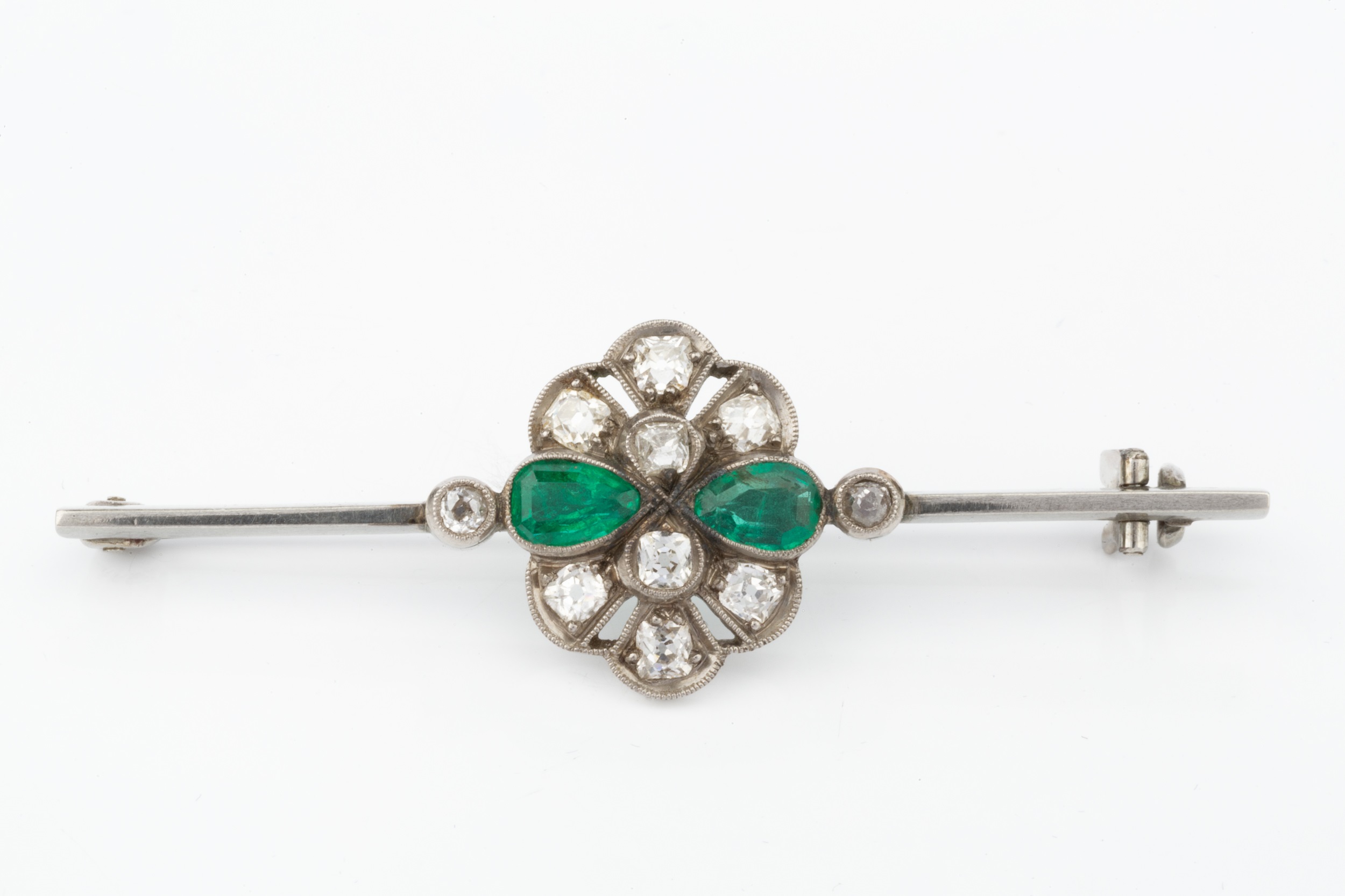 An emerald and diamond cluster bar brooch, the uniform bar centred with a pierced and millegrained - Image 5 of 6