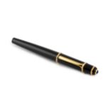 A Cartier ball point pen, in black with blue resin cabochon mounted lid, no. 106104, 14cm long