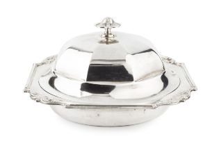 An Edwardian silver muffin dish and cover, the faceted domed cover with shaped finial, the dished