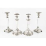 A pair of 19th century silver plated candlesticks, the knopped tapering stems with foliate scroll