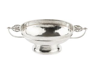 A silver Arts & Crafts design oval pedestal bowl, with planished body, twin foliate entwined