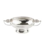 A silver Arts & Crafts design oval pedestal bowl, with planished body, twin foliate entwined