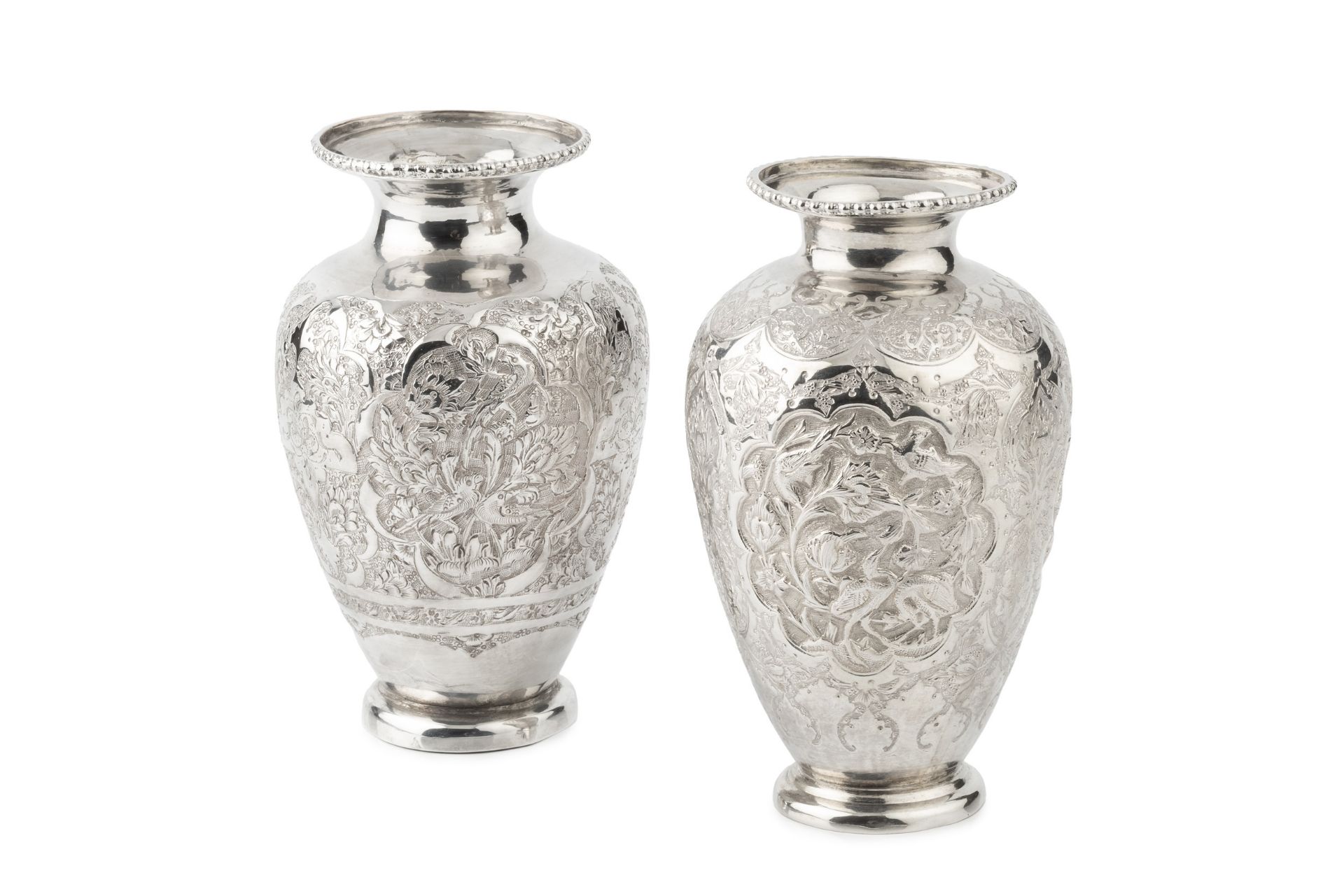 An Indian silver baluster vase, engraved and embossed with stylised flowering foliage within lobed