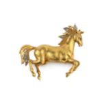 An 18ct gold and diamond set brooch, in the form of a prancing horse, the mane and tail set with