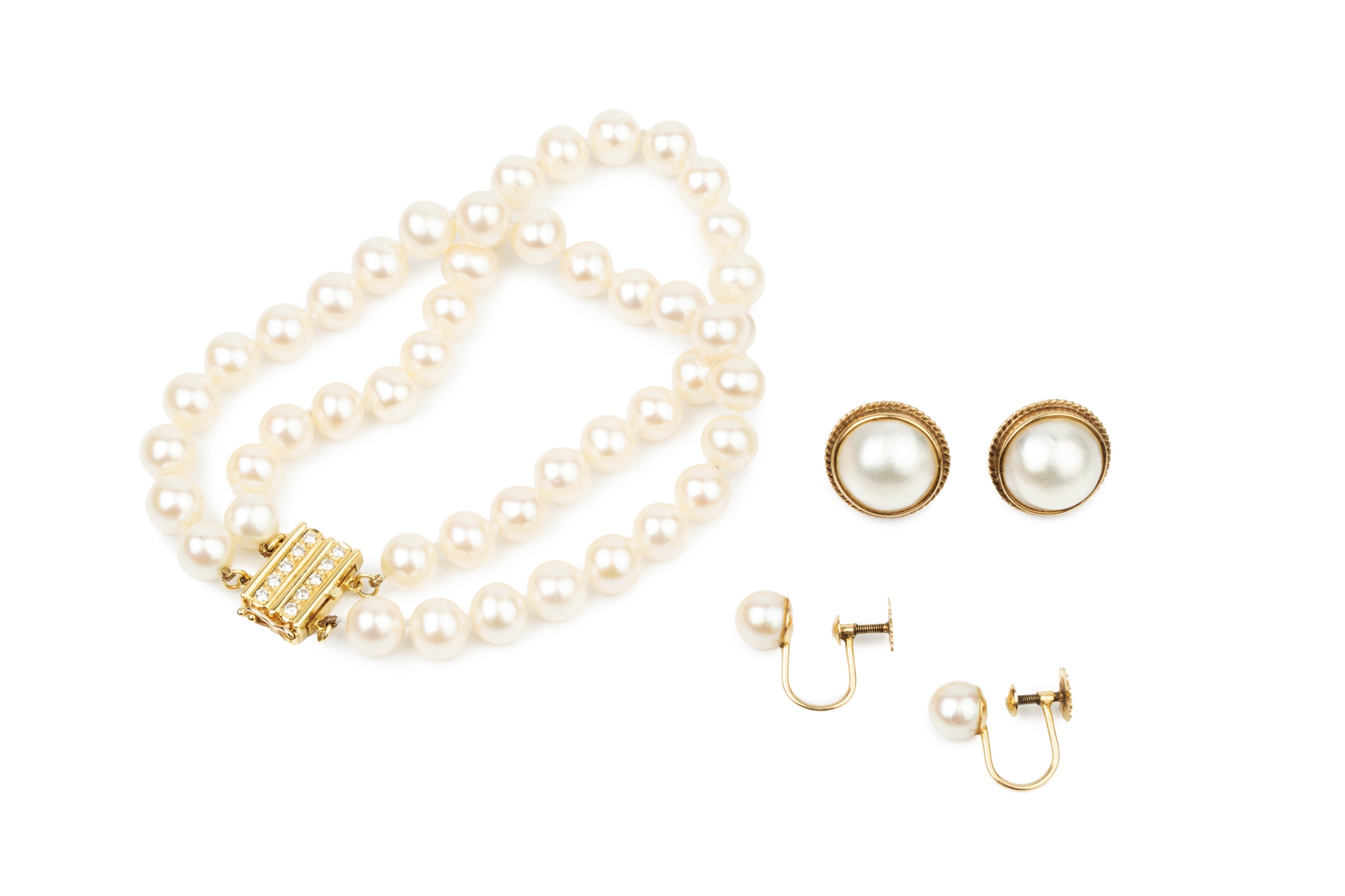 A twin strand uniform cultured pearl bracelet, the 18ct yellow gold clasp set with two lines of