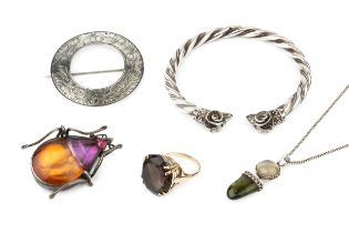 A quartz dress ring, the oval cut stone claw set to an unmarked yellow metal shank, a large silver