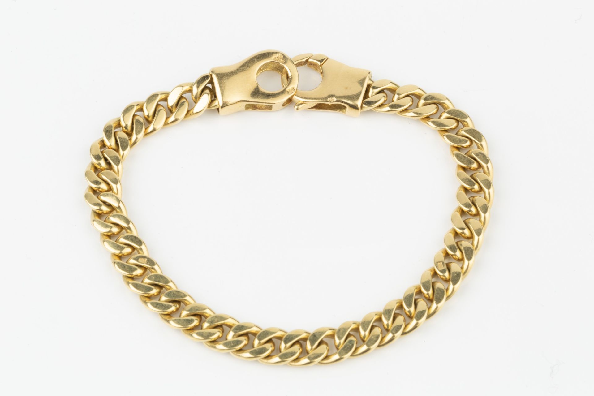 An 18ct gold curb link bracelet, the clasps stamped 750, 18.5cm long Weight approx 32.4g Width circa - Image 2 of 2