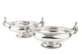 A pair of George V silver twin handled serving dishes, of circular form with gadrooned borders,