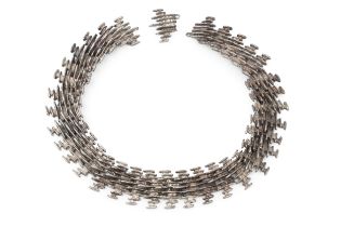 A silver collar necklace by Anthony Hawksley, composed of a series of cast textured links of
