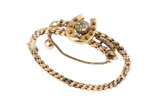 A Victorian gold hinged ropetwist bangle, of crossover design set with a horseshoe motif centred