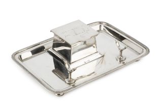 An Edwardian silver inkstand, the raised square section inkwell having hinged cover with