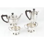 A George V silver four piece tea service, with gadrooned borders, the teapot and hot water pot