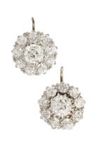 A pair of diamond cluster earrings, the central old cut stones each of approx 0.4ct within a