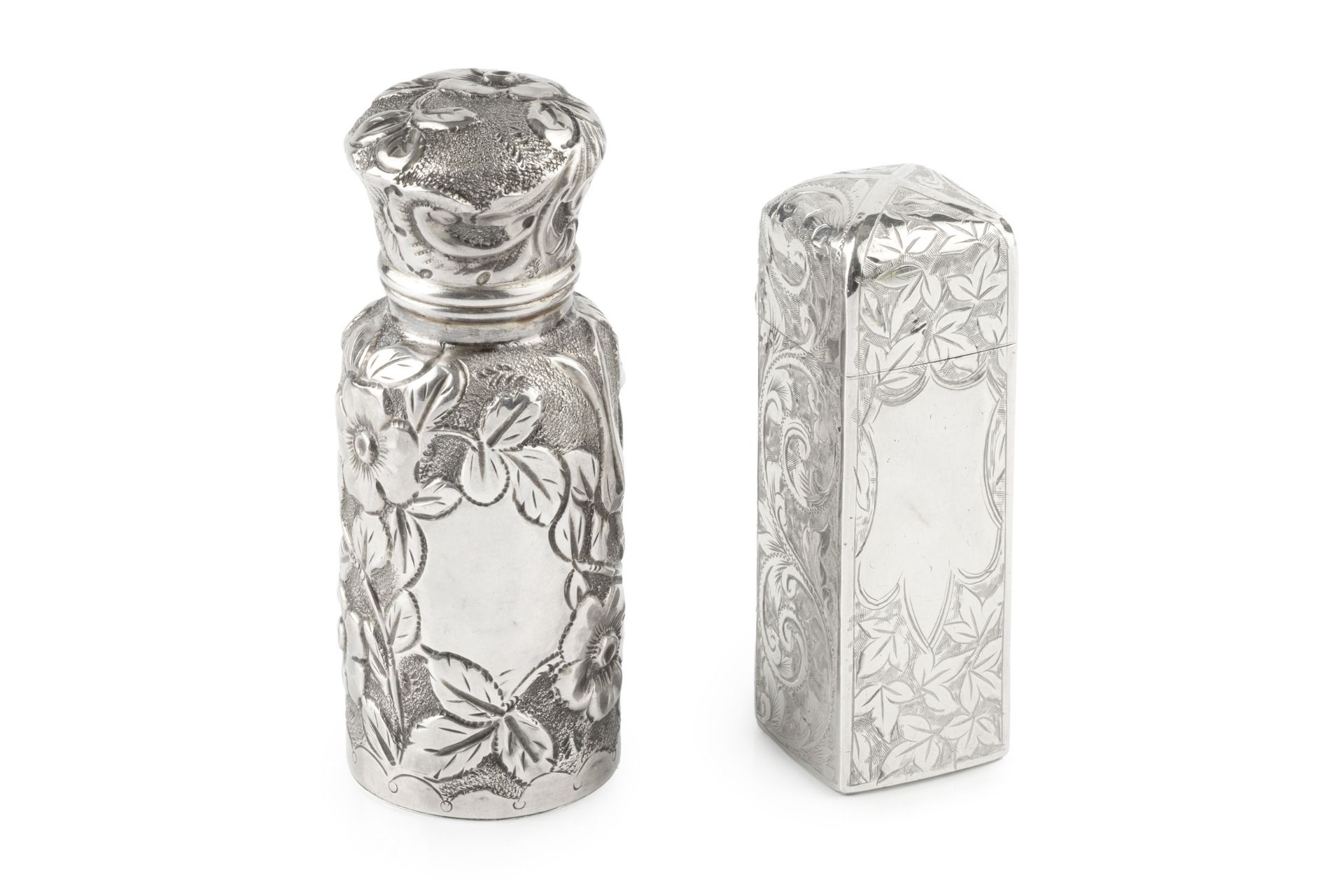 A late Victorian silver scent bottle, of cylindrical form with shaped hinged cover, embossed and