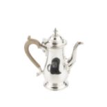 A silver bachelor's coffee pot, of baluster form, with hinged domed cover, scroll and leaf capped