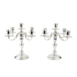 A pair of silver four branch five-light candelabra, the baluster columns having detachable pairs