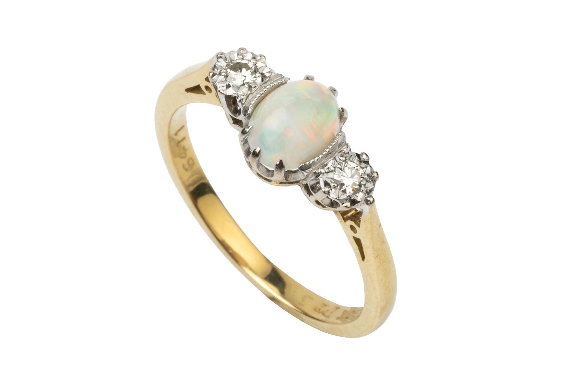 An opal and diamond three stone ring, the central oval cabochon opal flanked by a pair of small