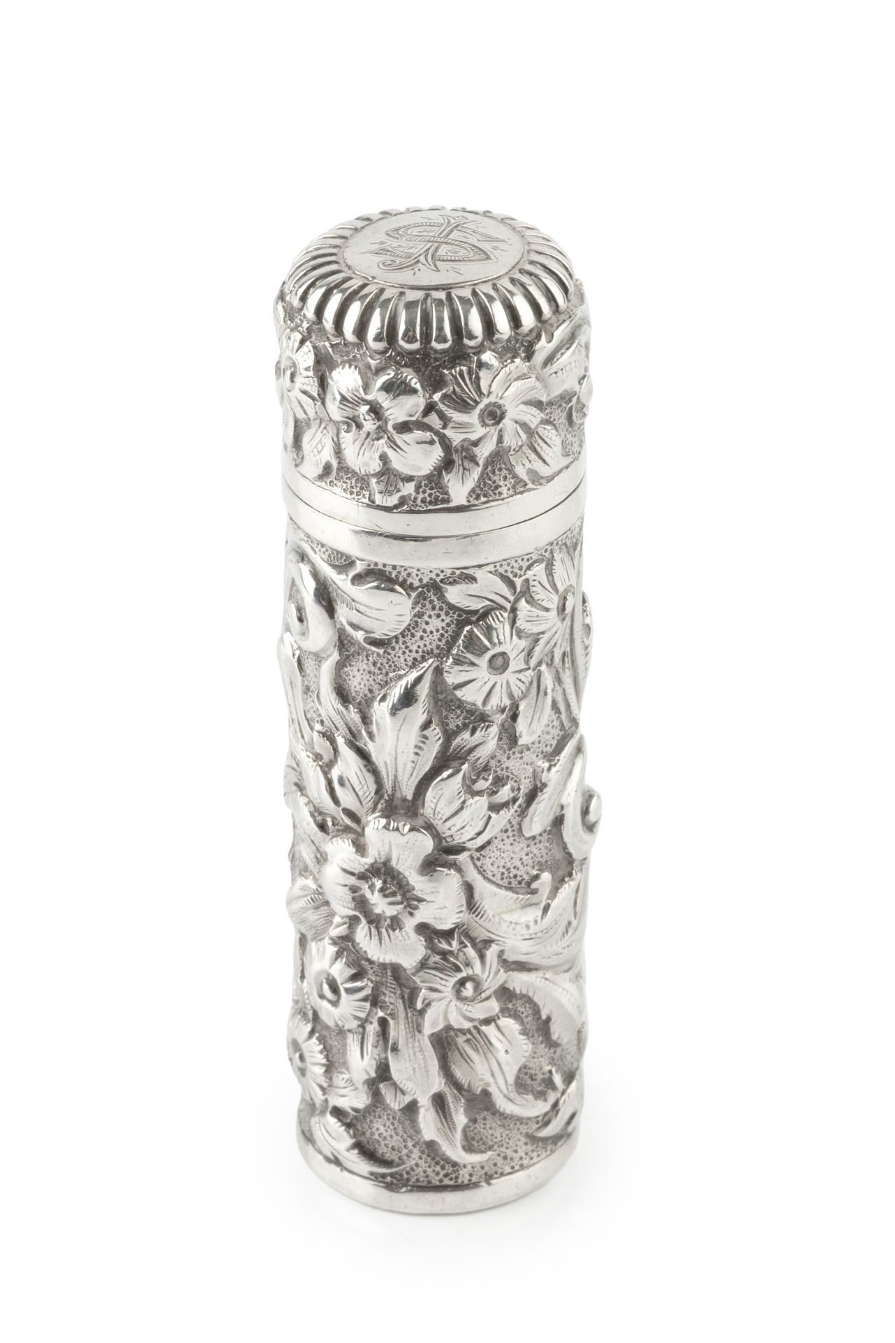 A late Victorian silver cylindrical scent bottle, embossed and engraved with stylised scrolling